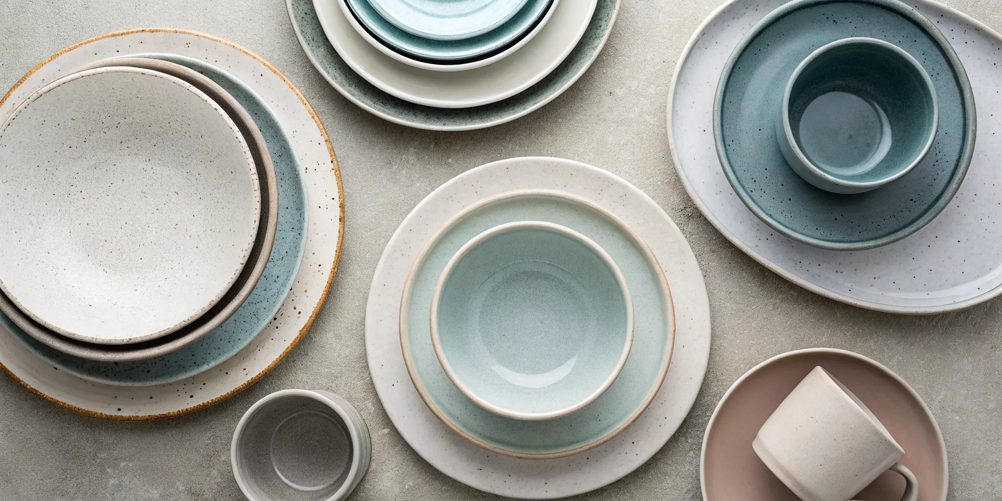 Rustic stoneware dinnerware in neutral and pastel colors.